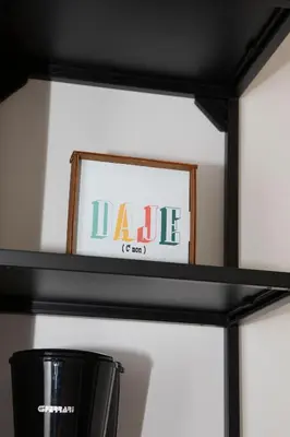 a black shelf with a sign that reads dale at Casa Carmine in Trastevere in Rome