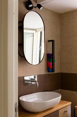 a bathroom with a white sink and a mirror at Casa Carmine in Trastevere in Rome