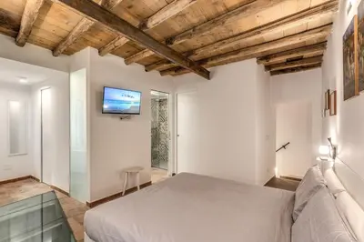 a bedroom with a bed and a tv on the wall at La Casa Dei Sogni in Rome