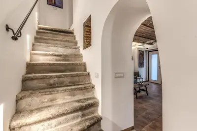 a stone staircase in a house with an archway at La Casa Dei Sogni in Rome