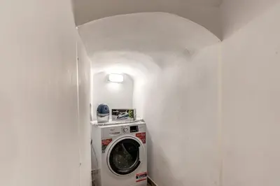 a washer and dryer in a room with a wall at La Casa Dei Sogni in Rome