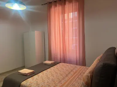 a bedroom with a bed with two towels on it at Rosa di San Giovanni in Rome