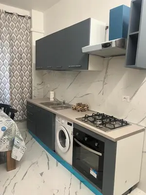 a kitchen with a stove and a washing machine at Rosa di San Giovanni in Rome