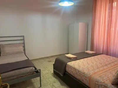 a bedroom with two beds in a room at Rosa di San Giovanni in Rome
