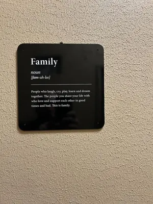 a plate on a wall with a family sign on it at Ferrari House in Rome