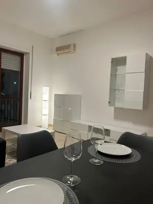 two wine glasses sitting on a table in a kitchen at Ferrari House in Rome