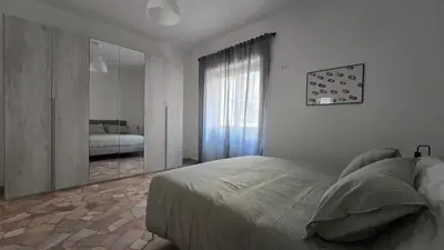 a bedroom with a bed and a mirror and a bed sidx sidx sidx at Ferrari House in Rome