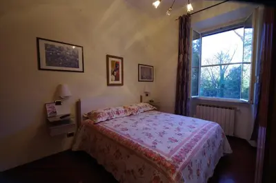 a bedroom with a bed and a window at Domus Roma G&R in Rome