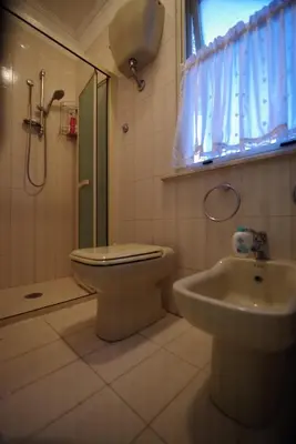 a bathroom with a shower and a toilet and a sink at Domus Roma G&R in Rome