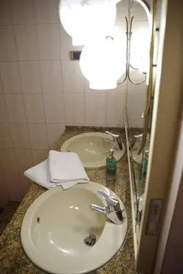 a bathroom with a sink and a mirror at Domus Roma G&R in Rome