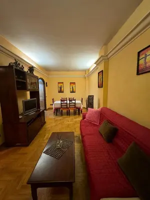 a living room with a red couch and a table at Tatyana appartament in Rome