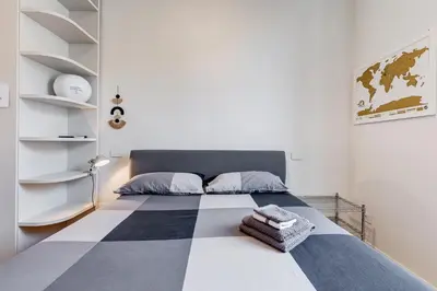 a bedroom with a bed with a black and white checkered floor at Modern flat in Vatican in Rome
