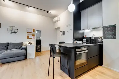 a kitchen and living room with a table and a couch at Modern flat in Vatican in Rome