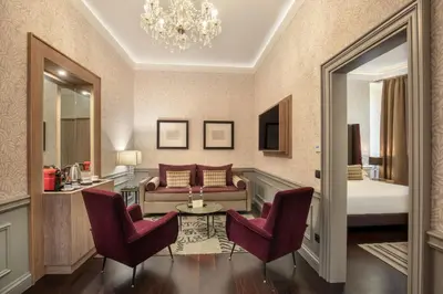 a living room with a couch and two chairs at The Inn at the Spanish Steps Elegant Collection - The Gem in Rome