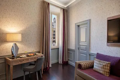a living room with a couch and a table at The Inn at the Spanish Steps Elegant Collection - The Gem in Rome