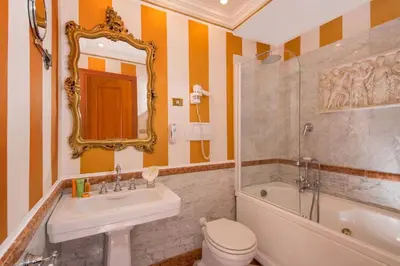 a bathroom with a tub and a sink and a toilet at The Inn at the Spanish Steps Elegant Collection - GioielloJewel in Rome