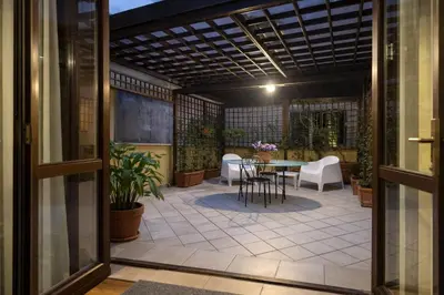 an outdoor patio with a table and chairs at Love Roma Termini Apartment with Terrace in Rome