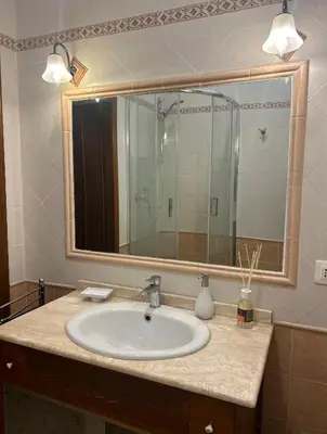 a bathroom with a sink and a large mirror at Love Roma Termini Apartment with Terrace in Rome