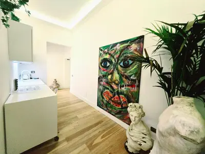 a kitchen with a painting on the wall and a plant at B89 Luxury Gallery House Piazza Di Spagna in Rome