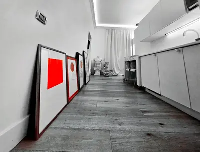 a hallway with a row of paintings on the wall at B89 Luxury Gallery House Piazza Di Spagna in Rome
