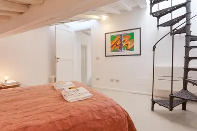 a bedroom with a orange bed in a white room at Rome as you feel - Baullari with terrace in Rome