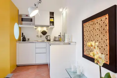 a kitchen with white cabinets and a counter top at Rome as you feel - Baullari with terrace in Rome
