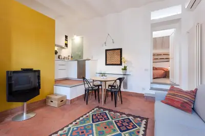 a living room with a couch and a table with chairs at Rome as you feel - Baullari with terrace in Rome