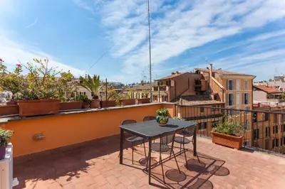 a patio with a table and chairs on a balcony at Rome as you feel - Baullari with terrace in Rome