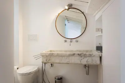 a bathroom with a sink and a mirror at Rome as you feel - Baullari with terrace in Rome