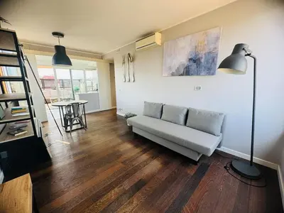 a living room with a couch and a table at 22APT Luxury quiet loft with terrace in Rome