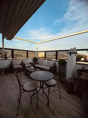 a balcony with a couch and a table and chairs at 22APT Luxury quiet loft with terrace in Rome