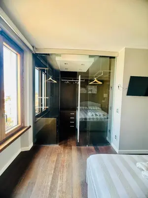 a bedroom with a bed and a glass wall at 22APT Luxury quiet loft with terrace in Rome