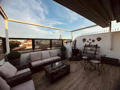 a living room with a couch and a table on a balcony at 22APT Luxury quiet loft with terrace in Rome