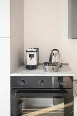 a kitchen with a stove top oven with a toaster at Alloggio per uso turistico Roma Casal Bertone - Casa del Sole in Rome