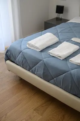 a bed with two white towels on top of it at Alloggio per uso turistico Roma Casal Bertone - Casa del Sole in Rome