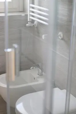 a bathroom with a white toilet and a sink at Alloggio per uso turistico Roma Casal Bertone - Casa del Sole in Rome