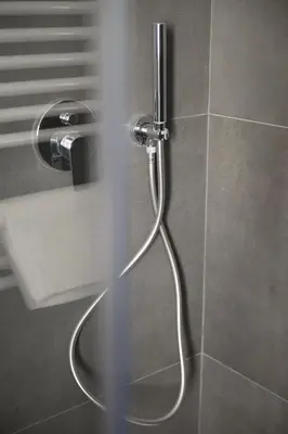 a shower with a hose in a bathroom at Alloggio per uso turistico Roma Casal Bertone - Casa del Sole in Rome