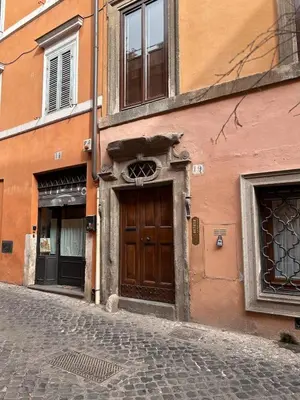 a building with a door on the side of a street at Colosseo Lovely studio apartment in Rome