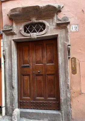 a wooden door on the side of a building at Colosseo Lovely studio apartment in Rome