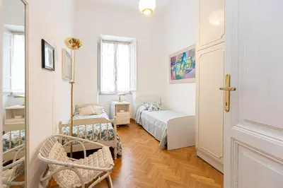 a small white room with a bed and a window at Amazing San Giovanni in Laterano in Rome