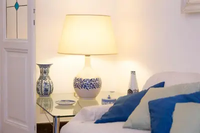 a lamp sitting on a glass table next to a bed at Amazing San Giovanni in Laterano in Rome
