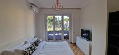 a room with a bed and a tv and a window at Nox Romana Apartments - Saint Peter - Large Flat with Terrace in Rome