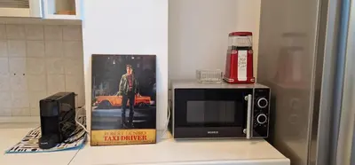 a microwave sitting on top of a kitchen counter at Nox Romana Apartments - Saint Peter - Large Flat with Terrace in Rome