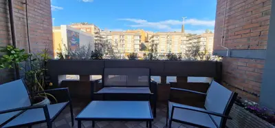 a balcony with two tables and chairs on a building at Nox Romana Apartments - Saint Peter - Large Flat with Terrace in Rome