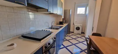 a kitchen with a sink and a counter top at Nox Romana Apartments - Saint Peter - Large Flat with Terrace in Rome