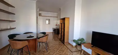 a living room with a table and chairs and a television at Nox Romana Apartments - Saint Peter - Large Flat with Terrace in Rome
