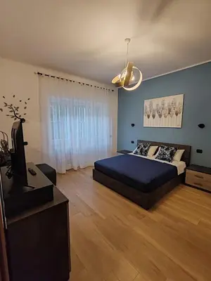 a bedroom with a bed and a flat screen tv at La casa di Ricky in Rome