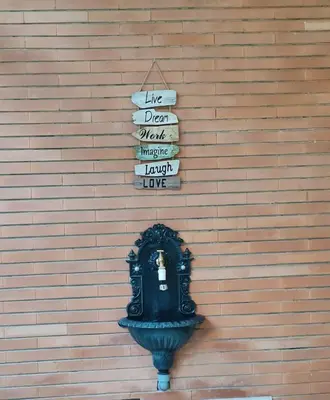 a wall with a sign and a clock on it at La casa di Ricky in Rome