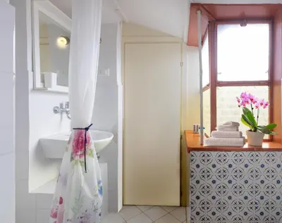 a bathroom with a sink and a toilet and a window at Principessa Trevi in Rome