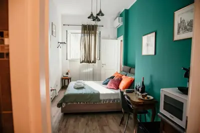 a bedroom with a bed and a green wall at Vatican Suite 